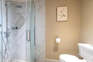 a bathroom with a shower with a toilet and a sink at 1 Bed in Brassington oc-dcneb in Brassington +7 photos