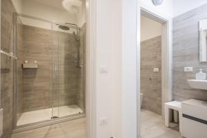 a bathroom with a shower and a toilet and a sink at MAGGIORE Affittacamere in Ravenna +34 photos