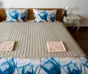 a large bed with two pillows on top of it at CENTRO House in Alytus