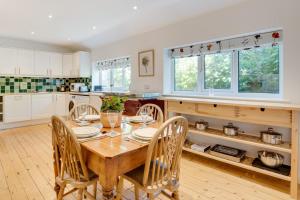 a kitchen with a wooden table and chairs at 2 Bed in Matlock oc-dcocc in Two Dales
