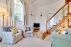 a living room with two chairs and a television at 2 Bed in Matlock oc-dcocc in Two Dales