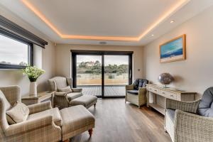 a living room with couches and chairs and windows at 5 Bed in Walmer oc-do022 in Kingsdown