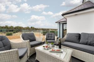 a patio with a couch and chairs and a table at 5 Bed in Walmer oc-do022 in Kingsdown