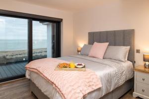 a bedroom with a bed with a tray of fruit on it at 5 Bed in Walmer oc-do022 in Kingsdown
