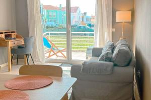 a living room with a couch and a large window at Marta Apartment - Balcony, Patio, Pool in Ferrel