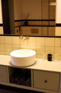 a bathroom with a white sink and a mirror at Huize Sonnevanck in Sexbierum