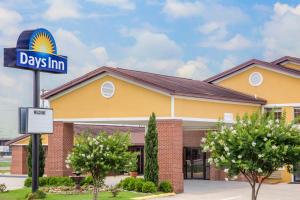 a days inn sign in front of a building at Days Inn by Wyndham Lake Village in Lake Village
