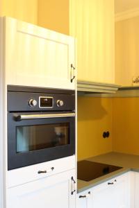 a kitchen with a black oven and white cabinets at Huize Sonnevanck in Sexbierum +22 photos