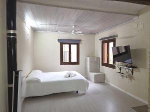 a bedroom with a bed and a flat screen tv at CAL MA Ponts in Ponst
