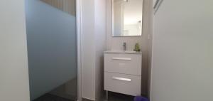 a bathroom with a sink and a mirror at CASA VIGNA - villa T4 piscine privée in Sainte-Lucie de Porto-Vecchio