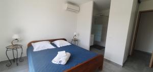 a bedroom with a bed with towels on it at CASA VIGNA - villa T4 piscine privée in Sainte-Lucie de Porto-Vecchio +6 photos