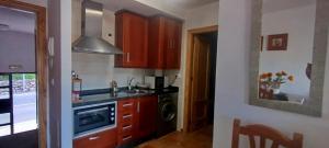 a kitchen with a sink and a stove top oven at VFT El Castillo in La Iruela