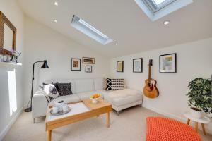 a living room with a white couch and a guitar at 1 Bed in Trimley St. Martin nr Felixstowe oc-obat in Trimley Heath