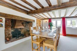 a dining room with a table and chairs and a fireplace at 5 Bed in Finningham oc-obhf in Finningham