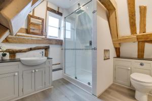 a bathroom with a shower and a toilet and a sink at 5 Bed in Finningham oc-obhf in Finningham +12 photos