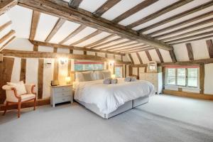 a bedroom with a large bed in a room with wooden ceilings at 5 Bed in Finningham oc-obhf in Finningham