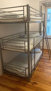 two bunk beds in a room with a wooden floor at Daora Lisbon Beds in Lisbon