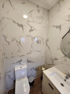 a bathroom with a toilet and a sink at Daora Lisbon Beds in Lisbon