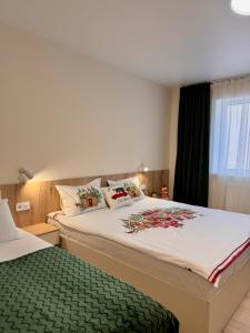 a bedroom with a large bed and a window at Рандеву in Slavske