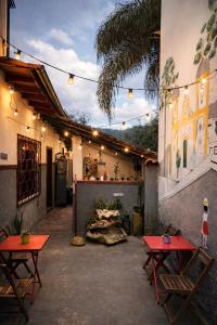 a patio with two tables and two chairs at Nuh Hostel in Ouro Preto