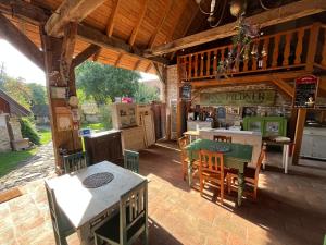 an outdoor kitchen with tables and chairs on a patio at Dominic Boutique - Atelier in Cloaşterf