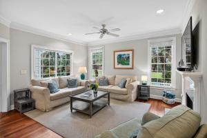 a living room with two couches and a fireplace at GE317: 317 Glen Eagle in Kiawah Island