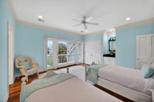 a bedroom with two beds and a ceiling fan at GE317: 317 Glen Eagle in Kiawah Island +58 photos
