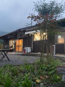 a house with a garden in front of it at おやど 瀬名 in Tanabe
