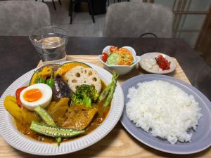 a plate of food with eggs and rice on a table at おやど 瀬名 in Tanabe