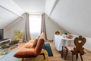 a living room with a table and a chair at Romantic 4-star suite with private heated pool in Gimbrett