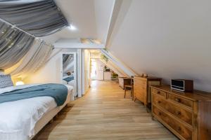 a bedroom with a bed and a wooden dresser at Romantic 4-star suite with private heated pool in Gimbrett +32 photos