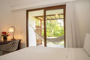 a bedroom with a swinging bed and a hammock at Arraial D'ajuda Eco Resort in Arraial d'Ajuda +121 photos