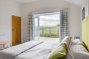 a bedroom with a bed and a view of the ocean at 2 Bed in Edgefield oc-2140 in Edgefield