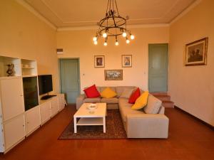 a living room with a couch and a table at Peaceful Holiday Home with Pool in Montefiridolfi Italy in Montefiridolfi