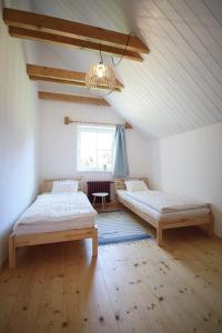 a bedroom with two beds and a window at Příchvoj 8 Český ráj in Sobotka