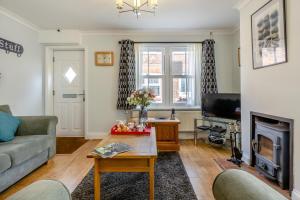 a living room with a couch and a fireplace at 2 Bed in Mundesley oc-1353 in Mundesley