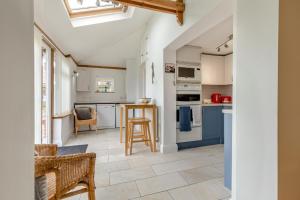 a kitchen with white cabinets and blue appliances at 2 Bed in Mundesley oc-1353 in Mundesley