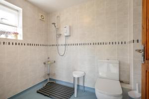 a bathroom with a toilet and a shower at 2 Bed in Mundesley oc-1353 in Mundesley +13 photos