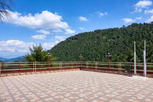 a balcony with a view of a mountain at M S Resort Dalhousie, Near mall road Gandhi Chowk Dalhousie in Dalhousie
