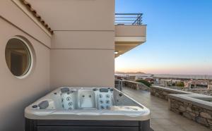 a bath tub sitting on top of a balcony at Alkis Dream Villa with Jacuzzi in Kos