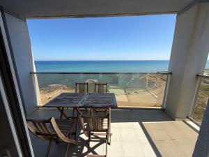 a table and chairs on a balcony with a view of the ocean at Veneziola Golf II by Alina365 in La Manga del Mar Menor