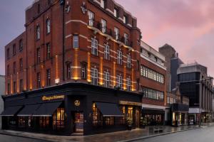 a large brick building on a city street at The Kensington Hideaway in London