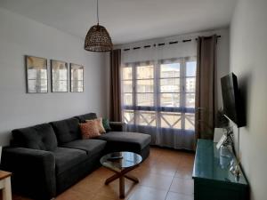 a living room with a couch and a tv at Apartamento Stefi in Arrecife