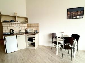 a kitchen and dining room with a table and chairs at ZOOM Apartments - Budapest in Budapest