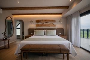 a bedroom with a large bed and a large window at Casa Pradera - Hotel Serrano in Sierra de los Padres