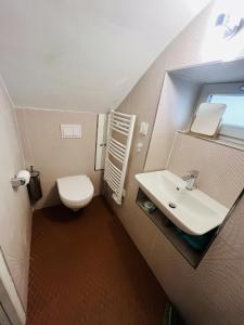 a small bathroom with a sink and a toilet at La tour de Grignan in Grignan +40 photos