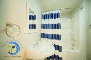 a bathroom with a sink and a shower at Cg Beach Bungalow #1 in Myrtle Beach +32 photos