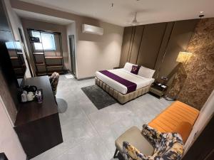 a hotel room with a bed and a couch at Western Banjara in Hyderabad