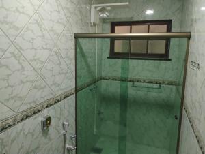 a shower with a glass door in a bathroom at Casa Tia Celinha e Cafeteria in Teresópolis +35 photos
