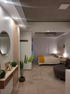 a bedroom with a bed and a couch in a room at Toscana Apart in San Miguel de Tucumán